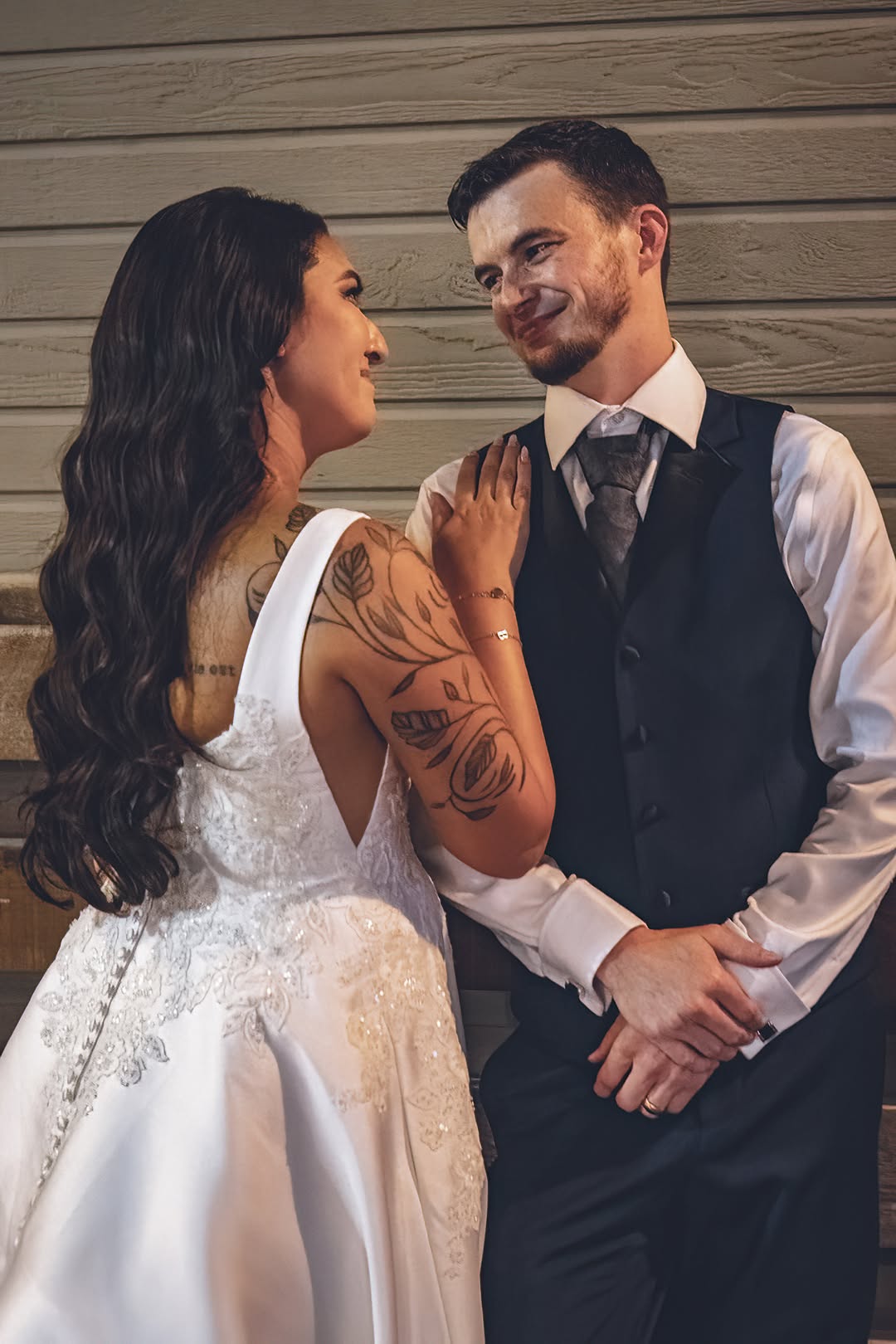 Newlyweds exchange a playful look
