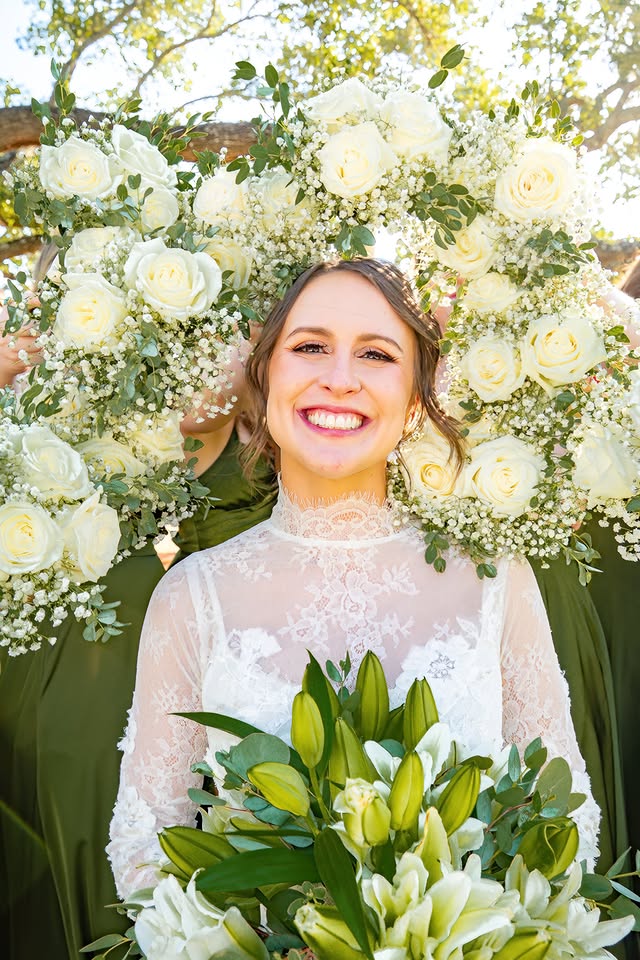 Bride framed by white wedding flowers